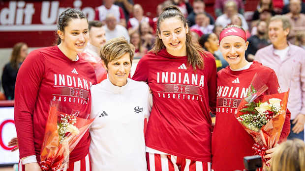 Indiana seniors Arielle Wisne, left, Head Coach Teri Moren, Mackenzie Holmes, second from right, and Sara Scalia, right, pose during Senior Day festivities before the start of the Indiana versus Maryland women's basketball game at Simon Skjodt Assembly Hall on Sunday, March 3, 2024.